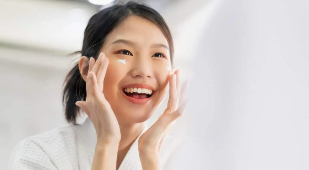 A Korean woman using skincare products